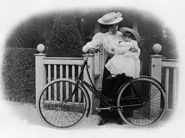 Beeston Humber cycle, Mrs. Hicks with child. Creator: Unknown