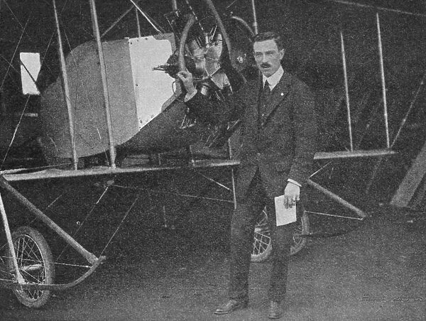 One of the best instructors: Lewis WF Turner standing by a Caudron training biplane, 1913 (1934). Artist: Flight Photo