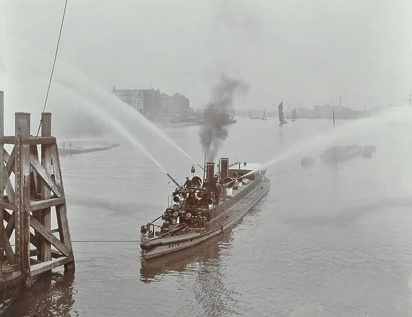 The Beta fire float with hoses, River Thames, London, 1910