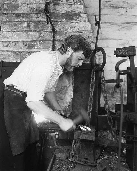 Black Country Museum, Birmingham, West Midlands, 1986. A blacksmith at work in a smithy