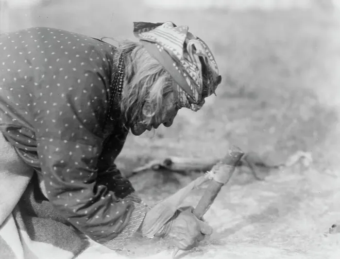 Framed Print : Blackfoot Indian fleshing a hide, c1927. Creator: Edward Sheriff Curtis Framed Print : Blackfoot Indian fleshing a hide, c1927. Creator: Edward Sheriff Curtis