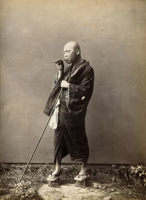 Framed Print : A blind Japanese masseur with a pipe in his mouth and a long pole in his hand, c1890s. Creator: Unknown Framed Print : A blind Japanese masseur with a pipe in his mouth and a long pole in his hand, c1890s. Creator: Unknown