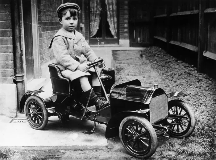 Framed Print : Boy in 1908 Mercedes 28 / 32 hp pedal car, c1908