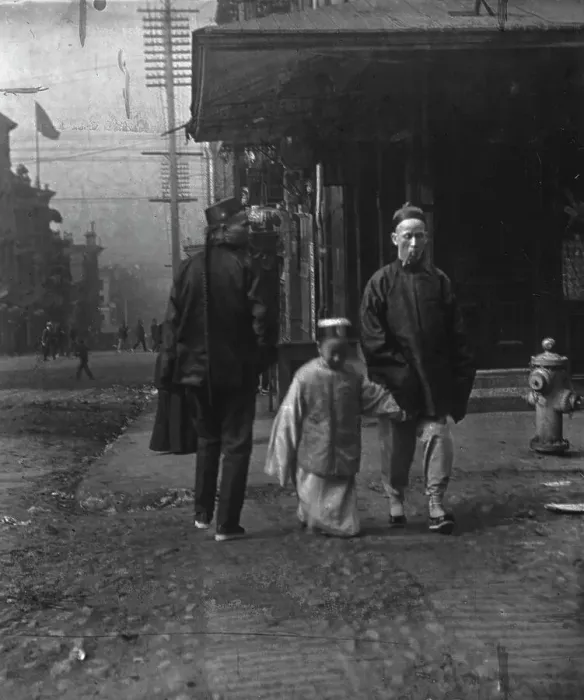 Framed Print : Boy and a man smoking a cigar crossing the street, San Francisco, between 1896 and 1906. Creator: Arnold Genthe Framed Print : Boy and a man smoking a cigar crossing the street, San Francisco, between 1896 and 1906. Creator: Arnold Genthe