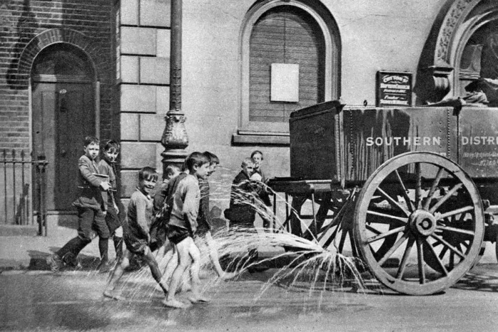 Framed Print : Boys following the Poplar Borough Council water cart, London, 1926-1927 Framed Print : Boys following the Poplar Borough Council water cart, London, 1926-1927