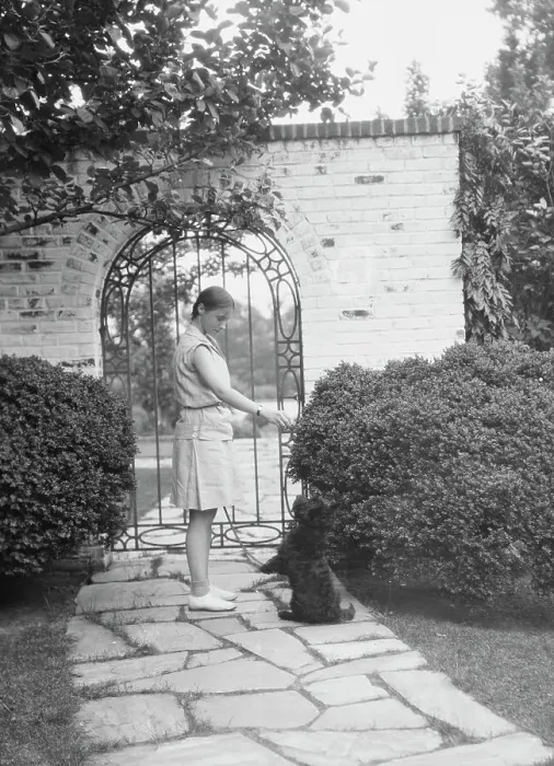 Framed Print : Brady, Genevieve, Miss, with dog, standing outdoors, between 1928 and 1931. Creator: Arnold Genthe Framed Print : Brady, Genevieve, Miss, with dog, standing outdoors, between 1928 and 1931. Creator: Arnold Genthe