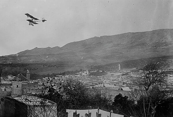 Breguet biplane, type 1910, flying over a town, possibly in Morocco, between c1910 and c1915. Creator: Bain News Service