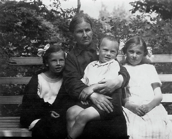 Briner Julius with his grandmother Anna Timofeevna Blagovidova, sisters Vera and Irina, 1924. Creator: Unknown