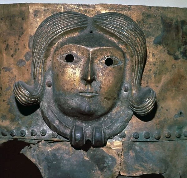 Detail of a bronze cauldron showing a human head wearing a Celtic torc, 4th century BC