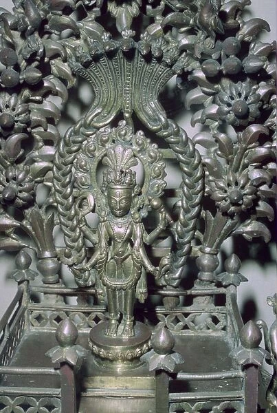 Bronze figure of Vishnu, protected by a many-headed serpent