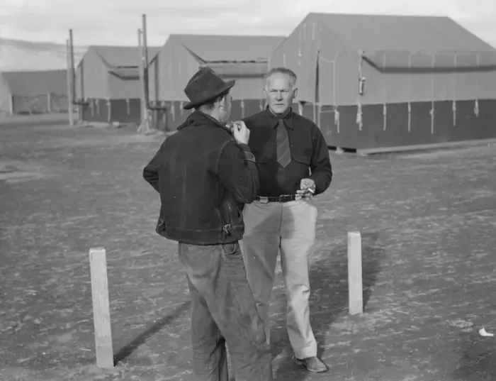 Framed Print : Camp manager talking to another man, FSA mobile camp, Merrill, Klamath County, Oregon, 1939. Creator: Dorothea Lange Framed Print : Camp manager talking to another man, FSA mobile camp, Merrill, Klamath County, Oregon, 1939. Creator: Dorothea Lange
