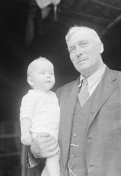 Captain Everett Edwards and baby, portrait photograph, 1933. Creator: Arnold Genthe