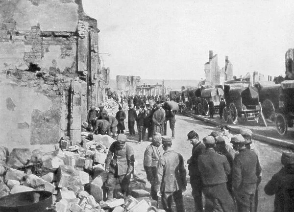 Captive German prisoners removing debris from the streets of Clermont-en-Argonne, France, 1914