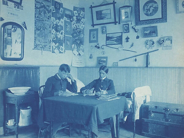 Carlisle Indian School, Carlisle, Pa. Two boys studying in dormitory room, 1901. Creator: Frances Benjamin Johnston