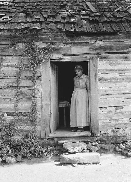 Caroline Atwater standing in the kitchen doorway of...log house, North Carolina, 1939. Creator: Dorothea Lange