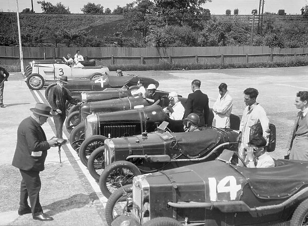 Cars on the start line for a motor race at Brooklands. Artist: Bill Brunell
