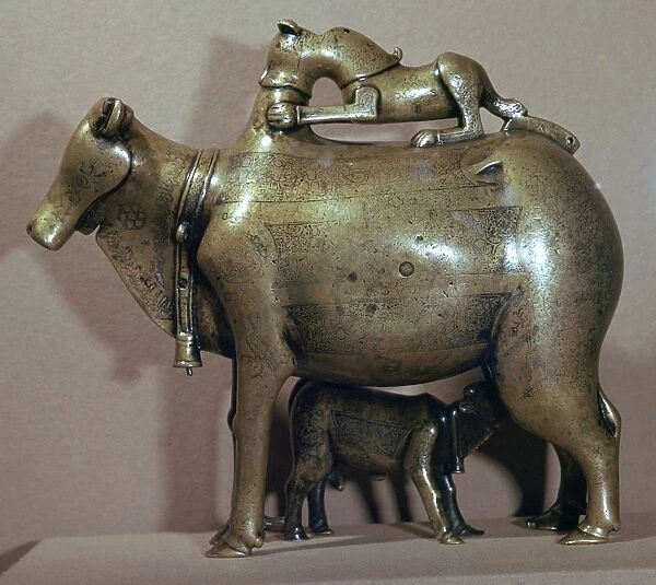 Cast bronze zebu-cow suckling her calf while a lion attacks her back, 13th century