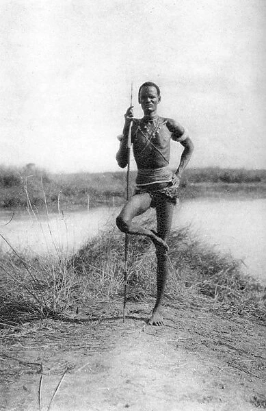 A characteristic Dinka attitude, Terrakekka to Aweil, Sudan, 1925 (1927). Artist: Thomas A Glover