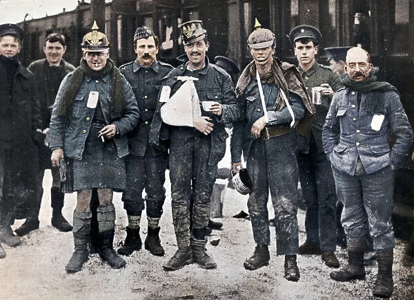 Some cheerful wounded from the Neuve Chapelle fighting, wearing captured German helmets, 1915