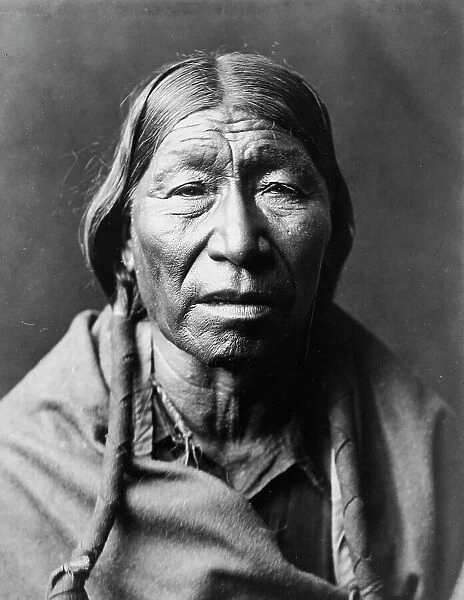 Cheyenne male, facing front, hair in wrapped braids, blanket around shoulders, c1910. Creator: Edward Sheriff Curtis