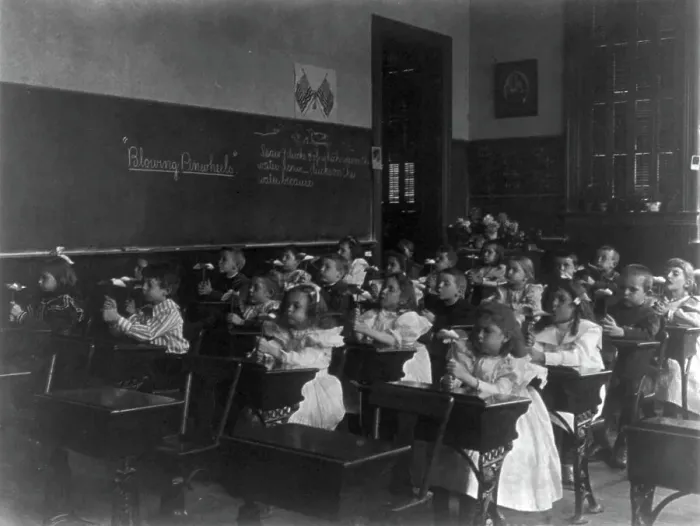 Framed Print : Children in a classroom blowing pinwheels in a Washington, D.C. grade school, (1899?). Creator: Frances Benjamin Johnston Framed Print : Children in a classroom blowing pinwheels in a Washington, D.C. grade school, (1899?). Creator: Frances Benjamin Johnston