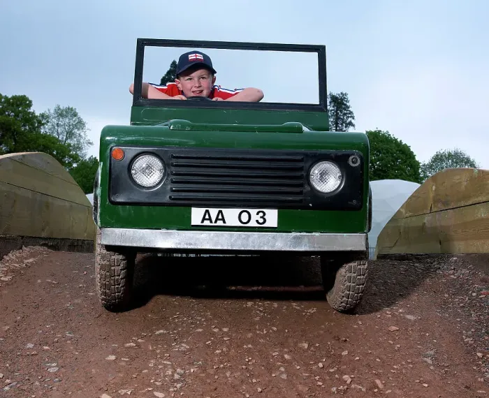 Framed Print : Children driving a toy Land Rover Framed Print : Children driving a toy Land Rover