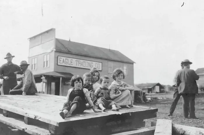 Framed Print : Children outside Eagle Trading Company, between c1900 and 1916. Creator: Unknown