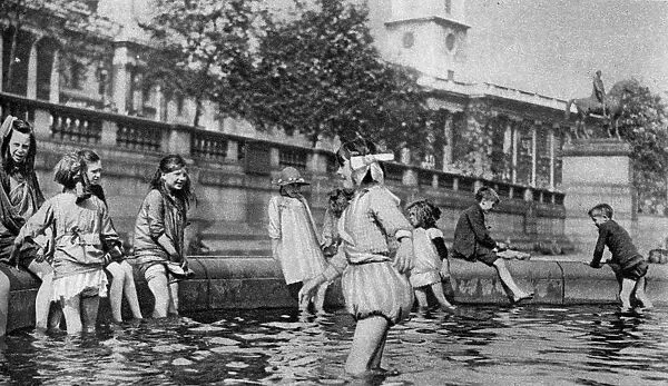 Children paddling in the fountains at Trafalgar Square, London, 1926-1927. Artist: Whiffin