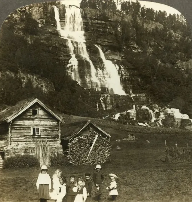 Framed Print : Children at play in a farmers field with terraced Tvinde waterfall, Vossevangen Framed Print : Children at play in a farmers field with terraced Tvinde waterfall, Vossevangen
