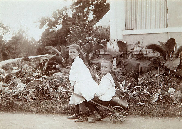 Two children playing outdoors, 1890s