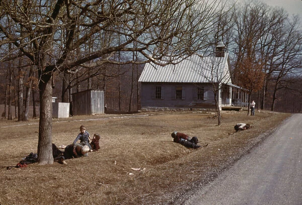 Children playing by road near school house, Kansas?, 1942 or 1943. Creator: John Vachon