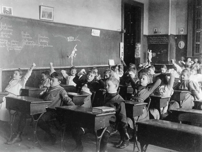 Framed Print : Children seated at desks in Washington, D.C. classroom, stretching, (1899?). Creator: Frances Benjamin Johnston Framed Print : Children seated at desks in Washington, D.C. classroom, stretching, (1899?). Creator: Frances Benjamin Johnston
