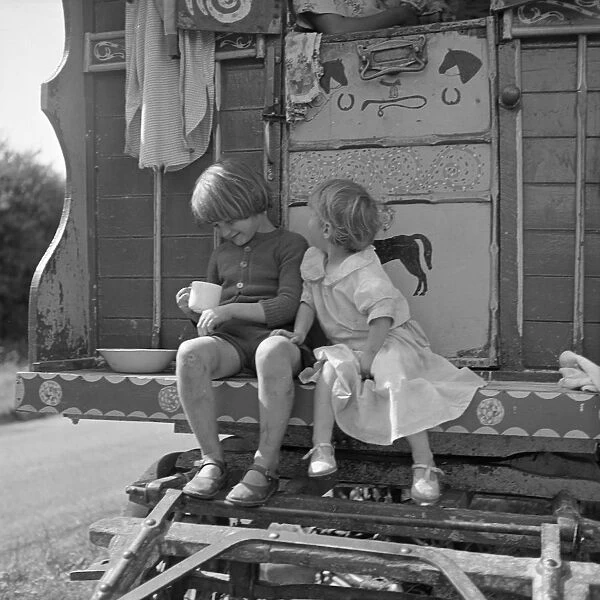 Children sitting on the steps of a gipsy caravan, Outwood, Surrey, 1963