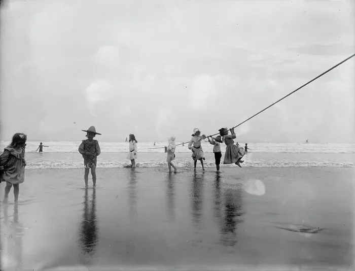 Framed Print : Children swinging on pier rope at beach, between 1900 and 1910. Creator: Unknown Framed Print : Children swinging on pier rope at beach, between 1900 and 1910. Creator: Unknown