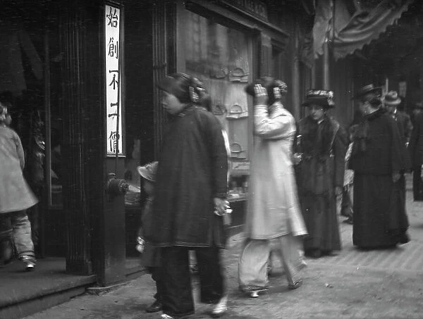 Chinese and American women walking down a street, Chinatown, San Francisco, between 1896 and 1906. Creator: Arnold Genthe