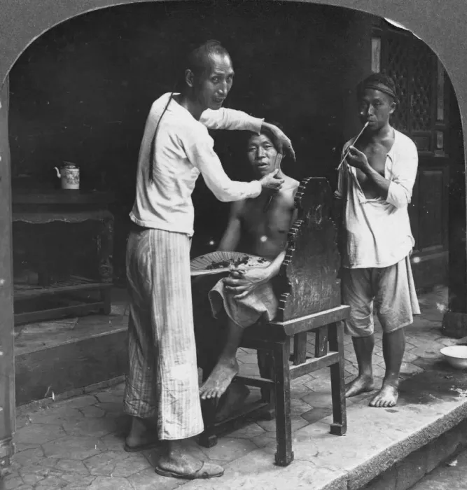 Framed Print : A Chinese barber at Bhamo, Burma, 1908. Artist: Stereo Travel Co Framed Print : A Chinese barber at Bhamo, Burma, 1908. Artist: Stereo Travel Co