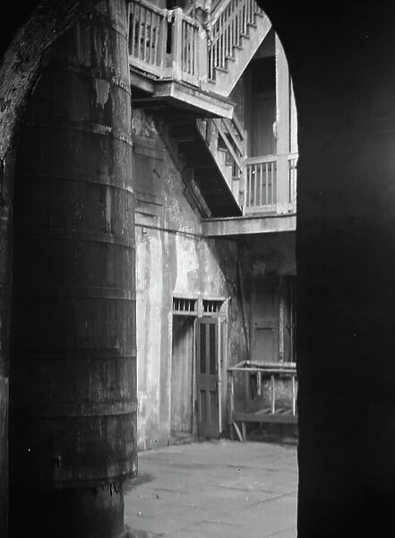 Cistern and outer stairs of an old-time courtyard, New Orleans, between 1920 and 1926. Creator: Arnold Genthe
