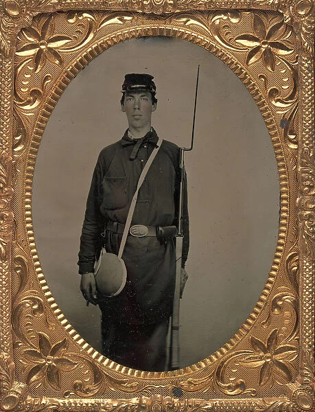 Civil War Union Soldier with Rifle and Canteen, in Studio, 1861-65. Creator: Unknown
