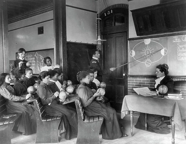A class in mathematical geography studying earth's rotation... Hampton Institute, Virginia, 1899. Creator: Frances Benjamin Johnston