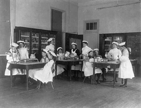 Classroom scene in Washington, D.C. elementary school - cooking class, (1899?). Creator: Frances Benjamin Johnston