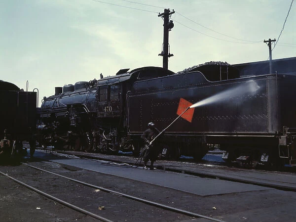 Cleaning an engine near the roundhouse, C. M. St. P. & P. R. R. Bensenville, Ill. 1943. Creator: Jack Delano
