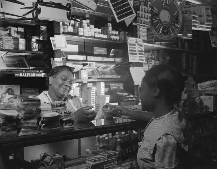 Framed Print : Clerk waiting on a customer in the store owned by Mr. J. Benjamin, Washington, D. C. 1942. Creator: Gordon Parks Framed Print : Clerk waiting on a customer in the store owned by Mr. J. Benjamin, Washington, D. C. 1942. Creator: Gordon Parks