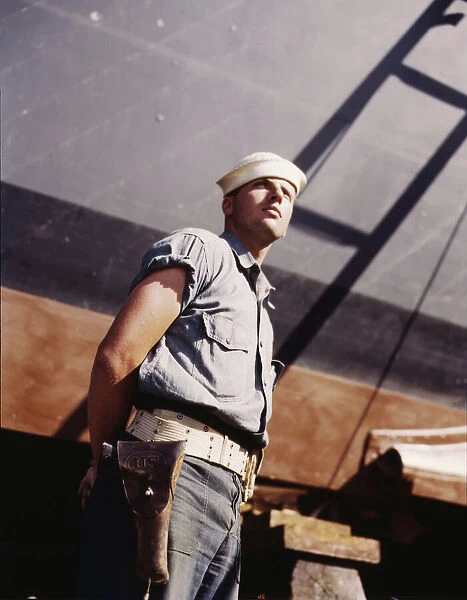 Coast Guardsman standing watch over 78-foot torpedo... Higgins Industries, Inc. New Orleans, 1942. Creator: Howard Hollem