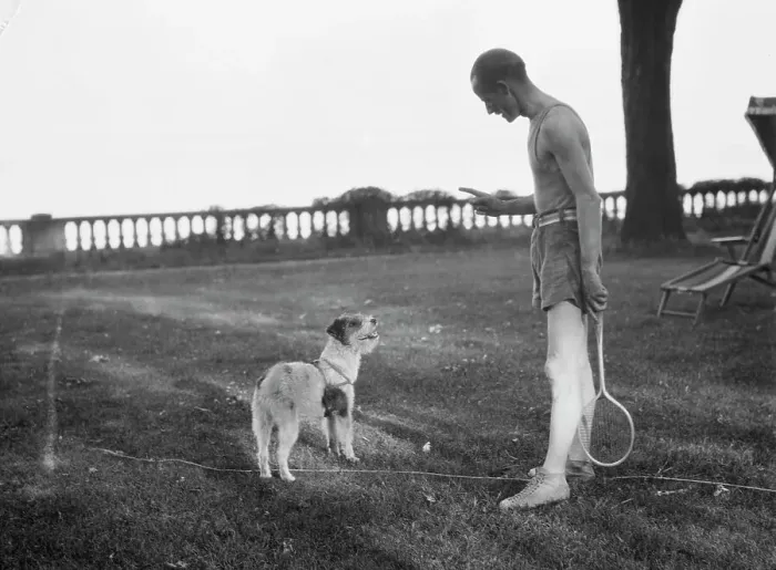 Framed Print : Cosgrave, Mr. with dog, outdoors, not before 1917. Creator: Arnold Genthe Framed Print : Cosgrave, Mr. with dog, outdoors, not before 1917. Creator: Arnold Genthe