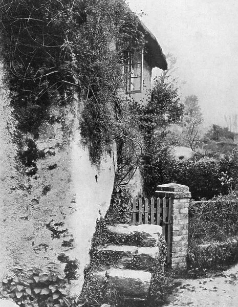 A cottage with an ancient upping stock, Cockington, Devon, 1924-1926. Artist: HJ Smith