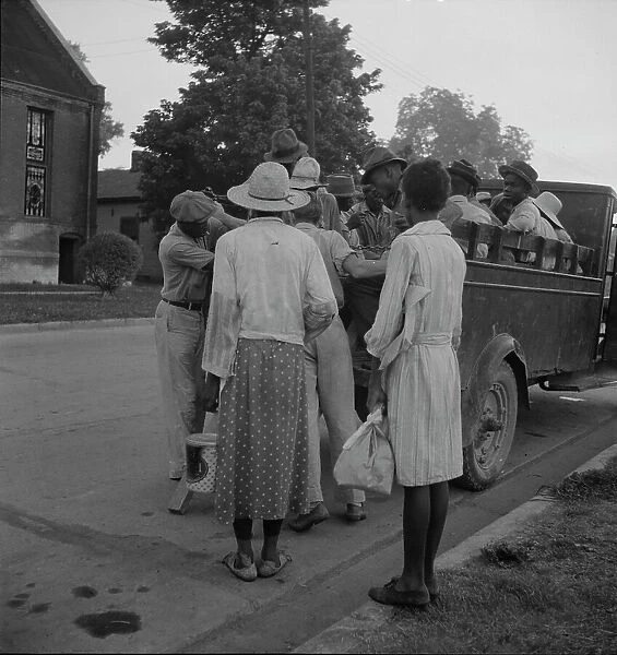 Cotton hoers leaving Greenville at 5 am for a day's work on the plantations, Mississippi, 1937. Creator: Dorothea Lange