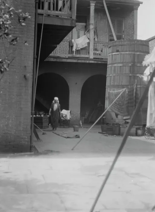 Framed Print : Courtyard with cistern and woman cleaning, New Orleans, between 1920 and 1926. Creator: Arnold Genthe Framed Print : Courtyard with cistern and woman cleaning, New Orleans, between 1920 and 1926. Creator: Arnold Genthe