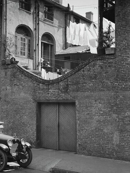 Courtyard with a garage, New Orleans, between 1920 and 1926. Creator: Arnold Genthe