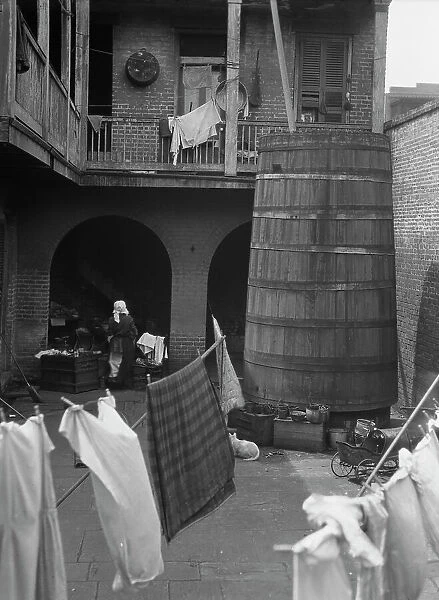 Courtyard with hanging laundry, New Orleans, between 1920 and 1926. Creator: Arnold Genthe