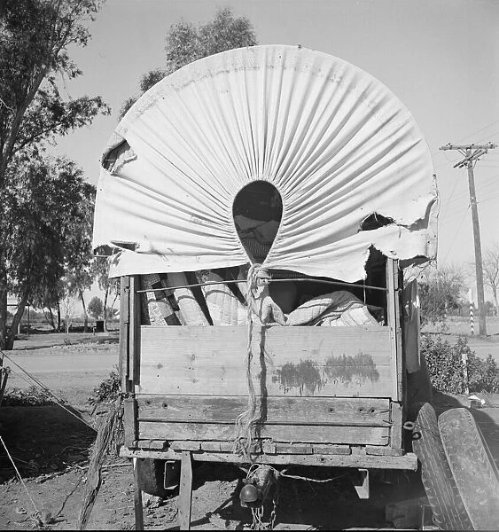 Covered wagon, migratory carrot pullers camp, near Holtville, Imperial Valley, 1939. Creator: Dorothea Lange
